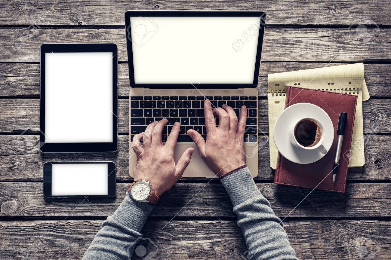 Top view man working with a laptop and tablet pc. Clipping paths included.